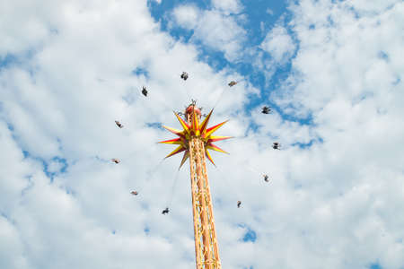 Kouvola, Finland - 10 August 2019: Ride Star Flyer in motion on cloudy sky background in amusement park Tykkimakiのeditorial素材