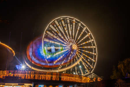 HELSINKI, FINLAND -OCTOBER 12, 2018: The Carnival of Light event at the Linnanmaki amusement park in Helsinki, Finland. Rides Ferris Wheel Rinkeli and Kehraのeditorial素材