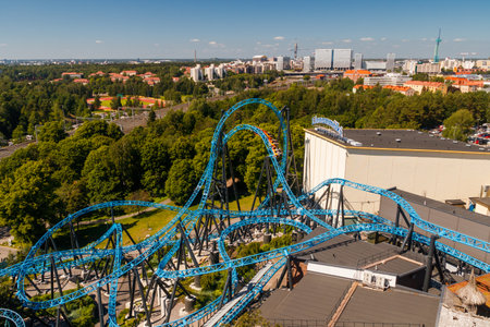Helsinki, Finland - 24 June 2022: Top view of Linnanmaki amusement park with roller coaster Taiga and Helsinki city.のeditorial素材