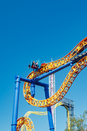 Helsinki, Finland - 24 June 2022: Ride roller coaster Kirnu in blurred motion on sky background in amusement park Linnanmakiのeditorial素材
