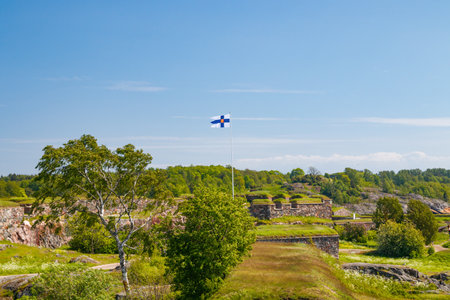 Finnish flag on the Suomenlinna Fortress in summer day in Helsinki, Finland.のeditorial素材