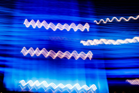 Abstract blurred colorful light effect on a black background. Long exposure photo of moving camera.の写真素材