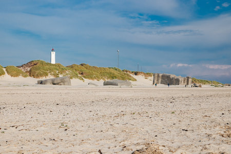 Lighthouse and bunkers in the sand dunes on the beach of Blavand, Jutland Denmark Europeの写真素材