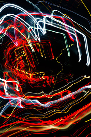 Abstract blurred colorful light effect on a black background. Long exposure photo of moving camera.