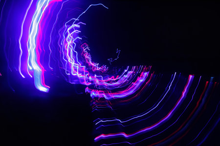 Abstract blurred colorful light effect on a black background. Long exposure photo of moving camera.