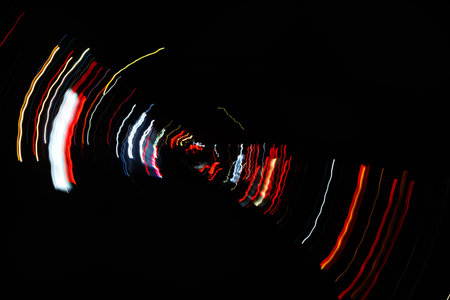 Abstract blurred colorful light effect on a black background. Long exposure photo of moving camera.