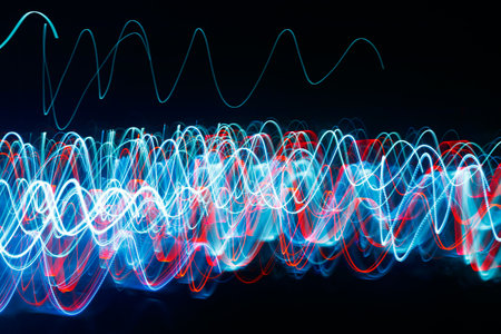 Abstract blurred colorful light effect on a black background. Long exposure photo of moving camera.