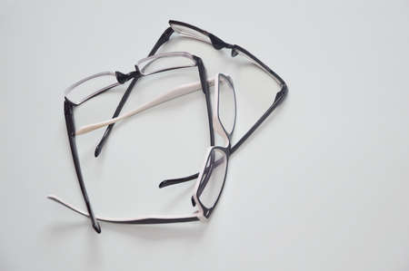 Glasses are transparent for reading or good vision, lie folded. on a light background. View from aboveの写真素材