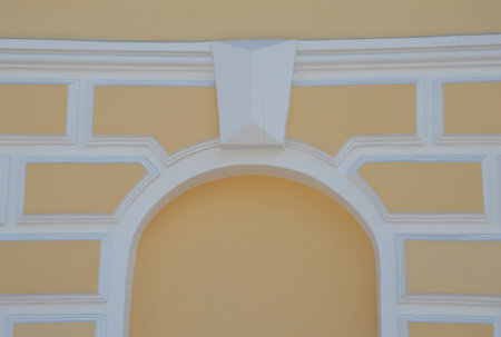 White arch against the background of the yellow facade of the restored building. wall decoration...