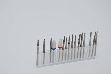 A set of cutters of different sizes in a stand container for hardware manicure. Manicure and...