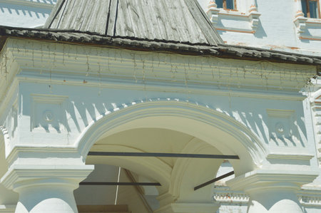 Architectural element of a white restored building with arches and roof against a blue sky.の写真素材