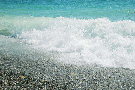 Sea, beautiful blue water with color transitions and splashes. Horizon line and clear sky.