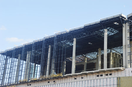 A fragment of a building under construction - roofs, ceilings, walls, rough window openings,...