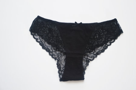Women's underwear. Black cotton panties with lace on a white background. Beautiful women's underwear. Front view.の写真素材