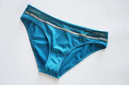 Women's turquoise swimsuit bikini panties on white background. Beachwear.