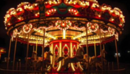 High resolution blurred picture with kids carousel with bright lights at night time.の写真素材