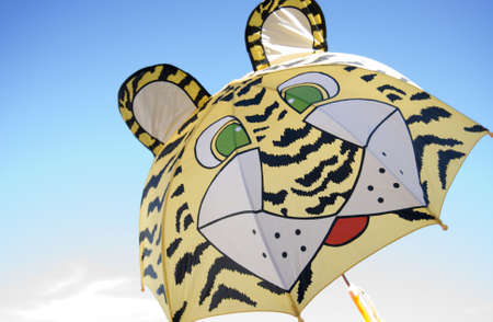 Umbrella- tiger   for children  on the blue sky の写真素材
