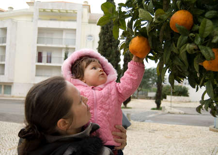 The little beatiful girl with her mather  ( 1 years old)の写真素材
