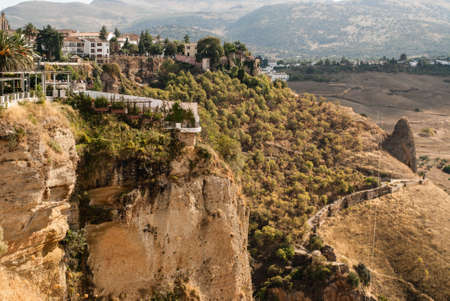 White spanish buildings built on the cliffs edge at Ronda, Spainの写真素材