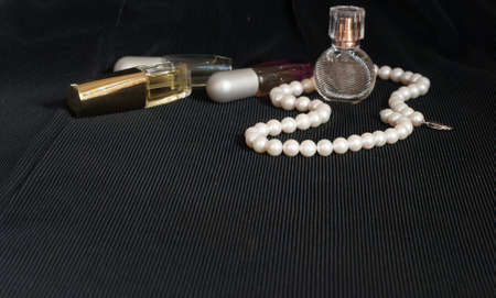 Pearl and perfume on black backgroundの写真素材