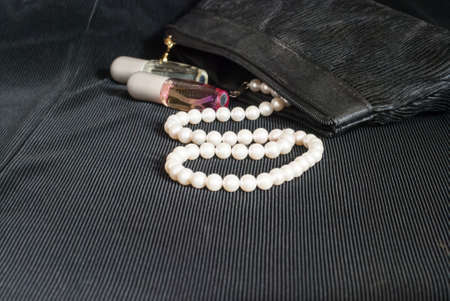 Pearl and perfume on black backgroundの写真素材