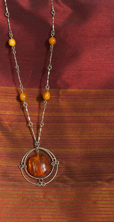 Amber necklace on  brown backgroundの写真素材