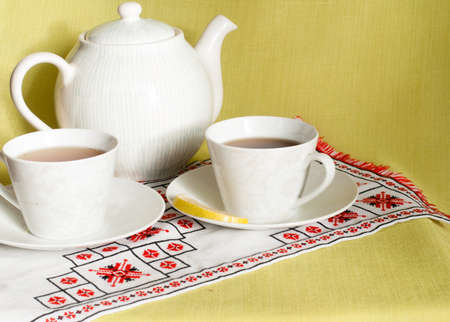 Cups of green tea with lemon and sweetの写真素材