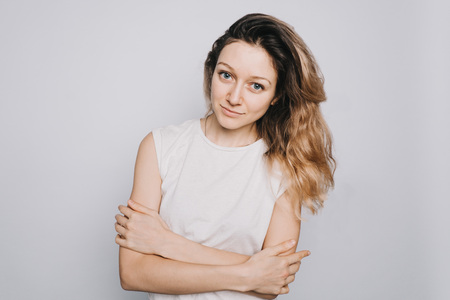 Young confident happy young Caucasian girl looking at camera on white background. Ambitious studentの写真素材