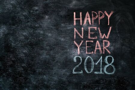 Happy 2018 new year card template with white chalk greetings on blackboard.の写真素材