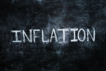 The word on The board, inflation, white chalk on black Boardの写真素材