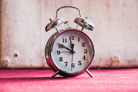 Retro alarm clock on a red white backgroundの写真素材
