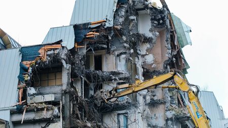 Demolition of an old building, time-lapse. Excavator destroys old buildingの写真素材