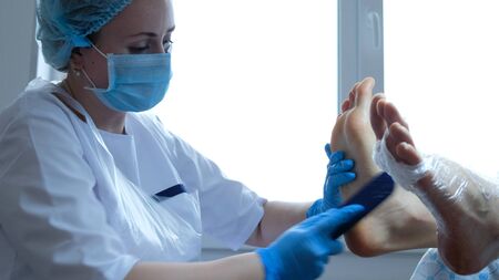 Girl cleans the old layer of skin with a foot tread - pedicure in the home office