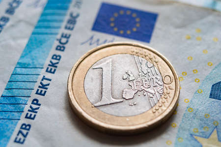 Euro coins on the background of paper bills, close upの写真素材
