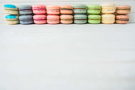 Macaroni or macaroons on a white wooden background. Almond cookies isolated, copy spaceの写真素材