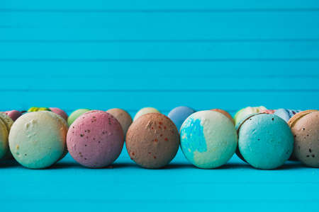 Macaroon on a turquoise wooden background, copy space.の写真素材