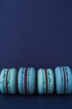 Blue macaroons on a violet background, copy space. Verticallyの写真素材