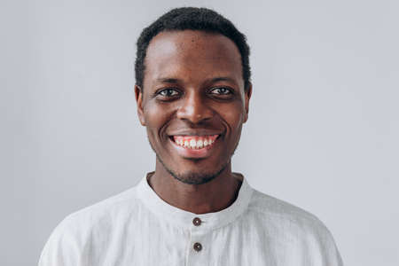 Portrait of handsome African-American man on grey backgroundの写真素材