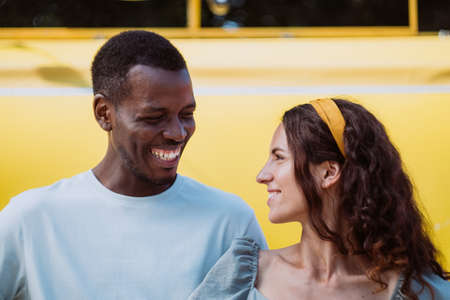 Afro-American man and brunette young woman look smilingの写真素材