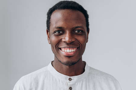 Portrait of handsome African-American man on grey backgroundの写真素材