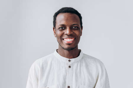 Portrait of handsome African-American man on grey backgroundの写真素材