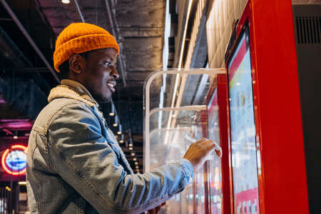 African-American guy orders food with self service kioskの写真素材