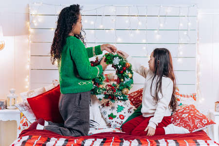 African American mother and daughter decorate living roomの写真素材