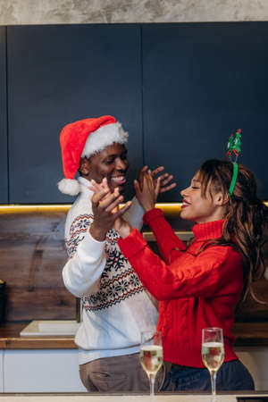 Black man and white woman dance in Christmas atmosphereの写真素材
