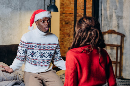 Black man talks with girlfriend in Christmas atmosphereの写真素材