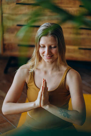 Athletic woman meditates with smile sitting in lotus poseの写真素材