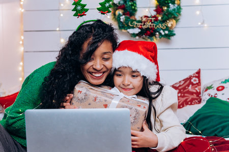 Black mother and daughter communicate via video callの写真素材