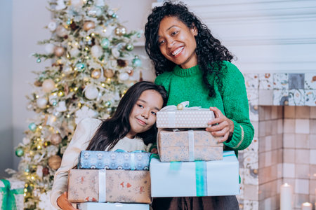 Mother and daughter hold Christmas presents huggingの写真素材