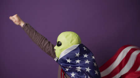 Humanoid pretends being superhero with American flagの写真素材