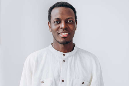 Portrait of handsome African-American man on grey backgroundの写真素材